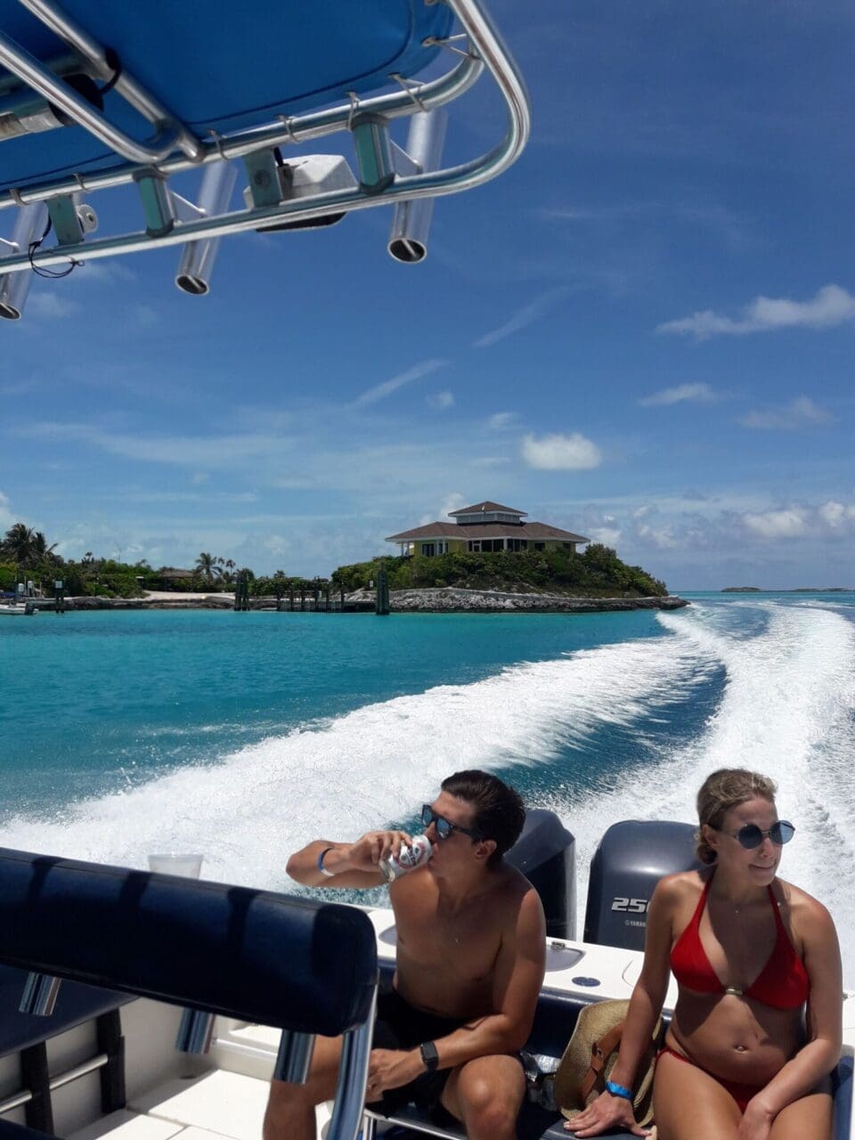 Two people on a boat in the ocean.