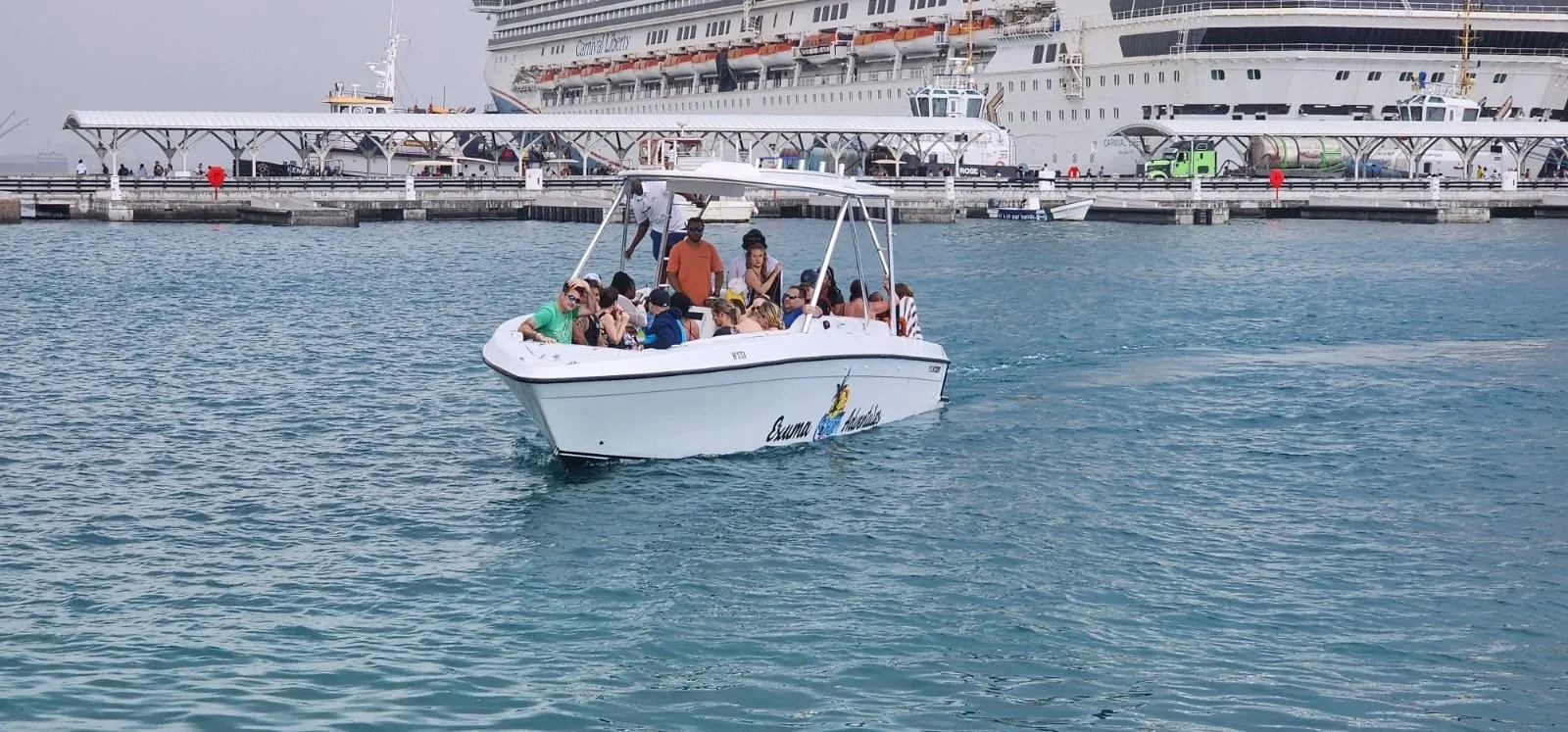 A boat with people in it is floating on the water.