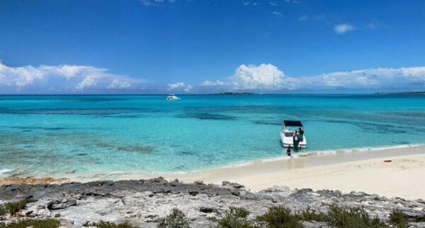 A boat is parked on the beach near the water.