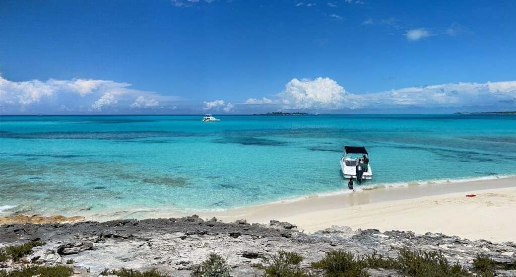 A boat is parked on the beach near the water.